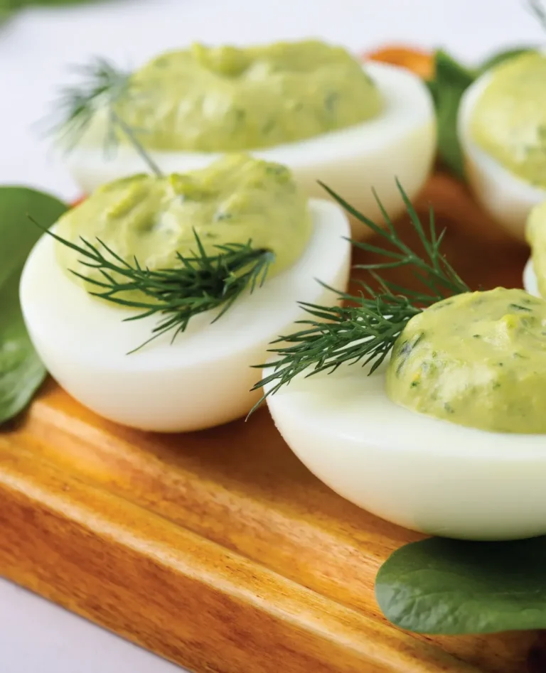 deviled eggs using avocados and sprig of green herb