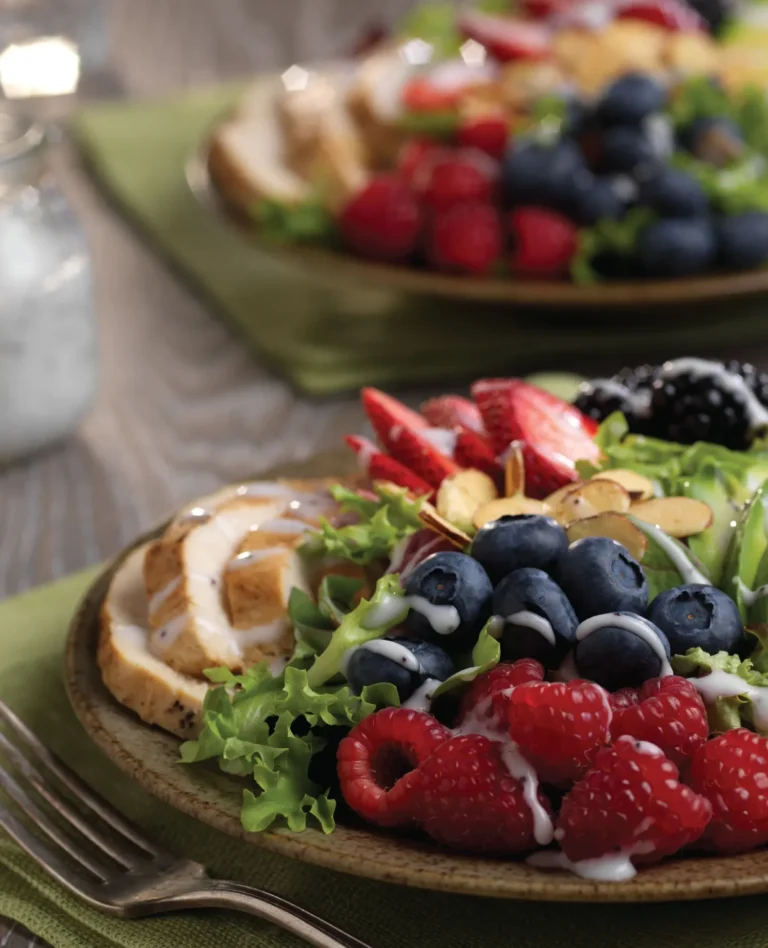 Naturipe 4-Berry Harvest Salad with Almond Slivers and Turkey on plate with silverware on table