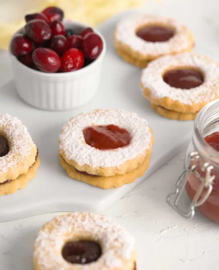 small butter cookies with cranberry jam in center