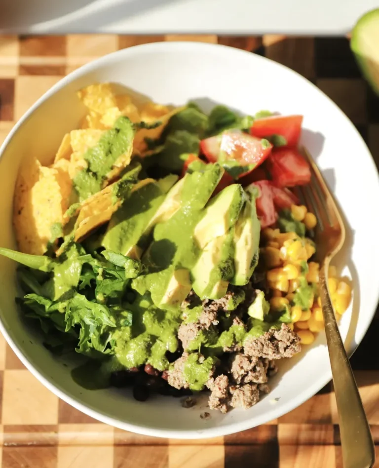 white bowl of protein taco meat bowl with avocados and other ingredients