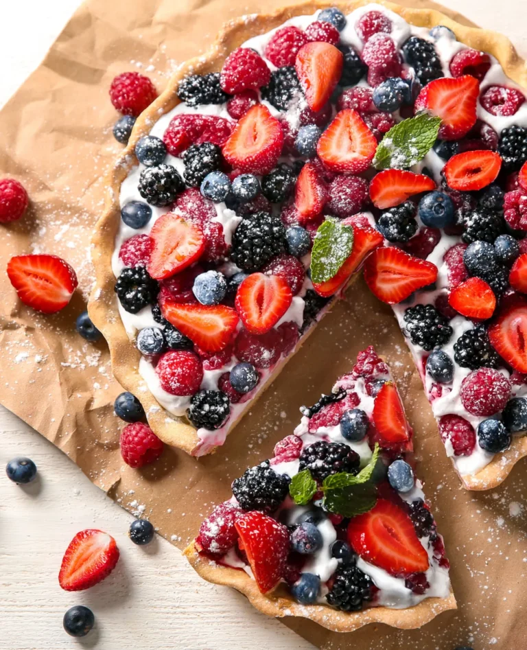 cream tart with strawberries, blueberries, and other fruit