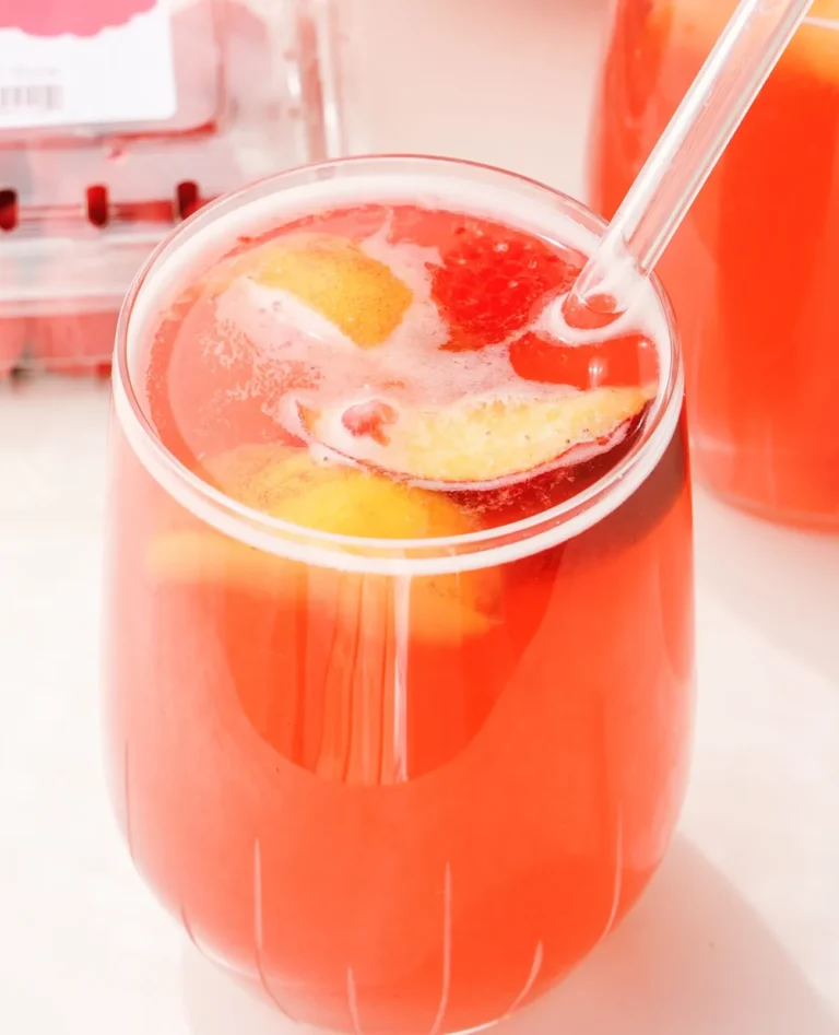 clear glass of raspberry sangria with straw