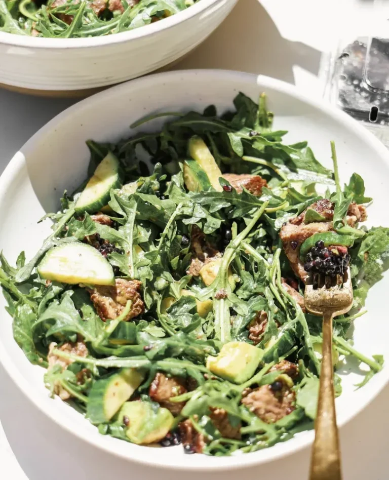 salad in white bowl with steak and berries